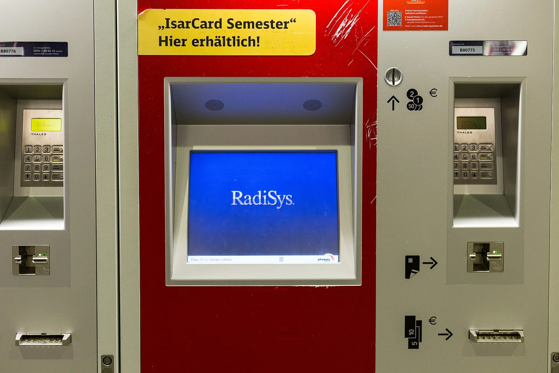 A red Deutsche Bahn ticket machine whose screen shows a blue startup screen instead of the ticket menu