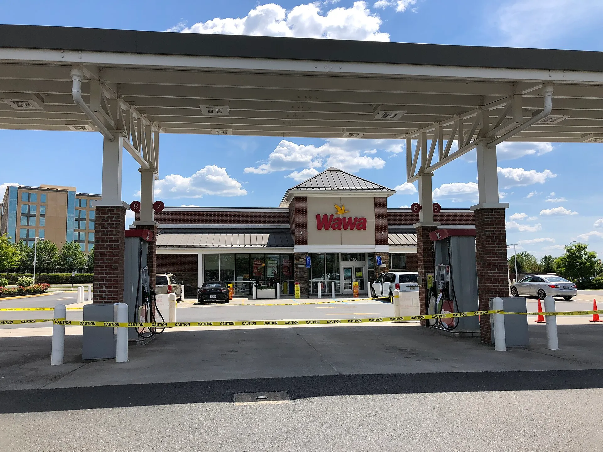 Petrol pumps wrapped in yellow caution tape at a Wawa station