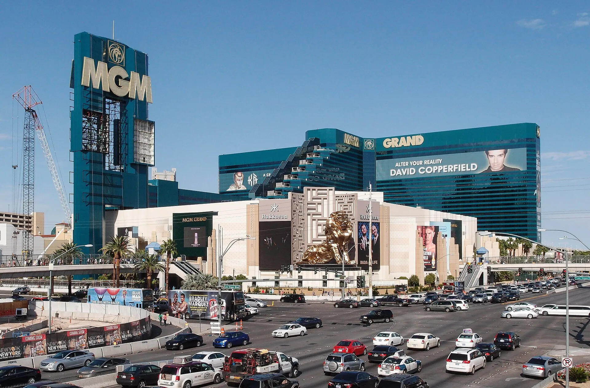 The MGM Grand hotel towers and lion statue above traffic on the Las Vegas Strip